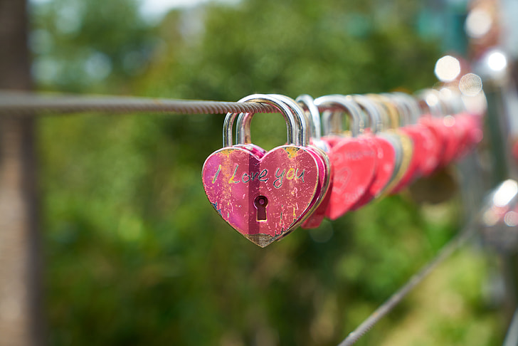 selective focus photography of heart-shaped red padlock