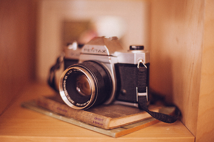 shallow focus photography of Pentax SLR camera