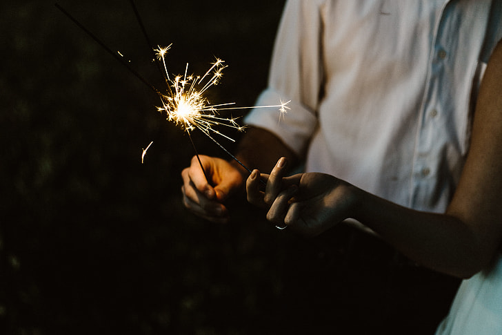 person holding sparklers