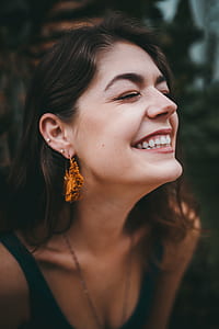 woman wearing brown tassel drop earrings