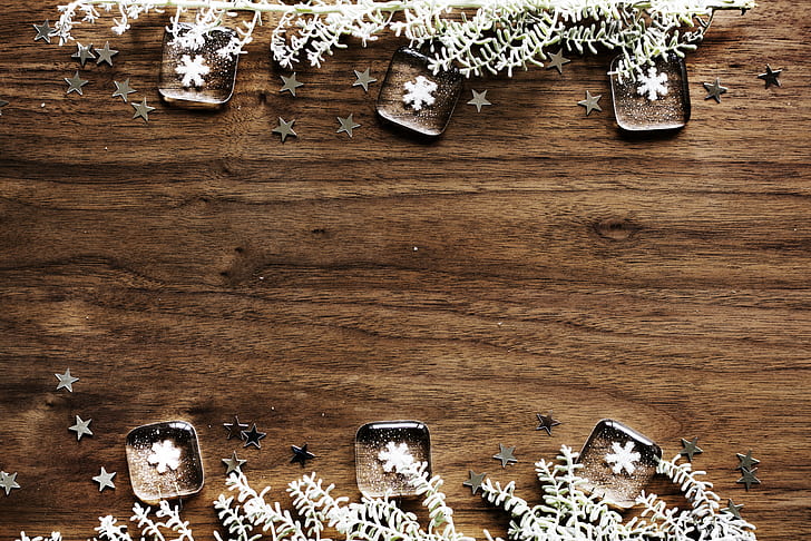 six snowflake paperweights on brown wooden tabletop
