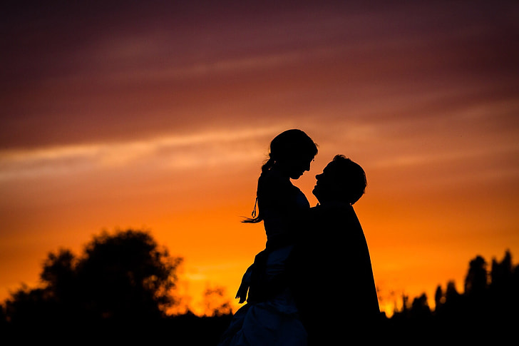 silhouette of woman and man in golden hour photography