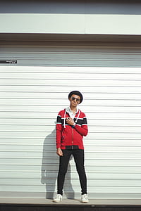 Man In Red And Black Zip-up Jacket And Black Pants With Black Hat