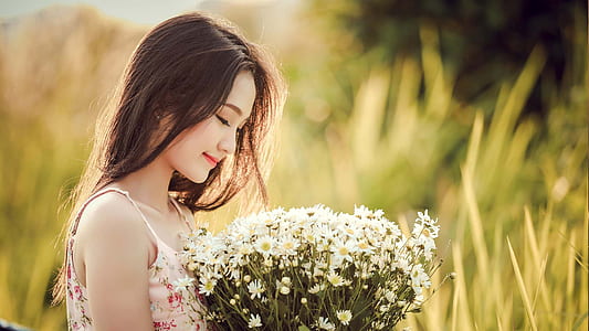 photo of person holding white flowers