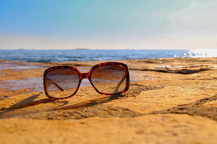 tortoiseshell framed sunglasses on brown sand