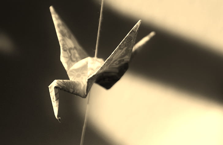 selective focus photography of grey crane origami
