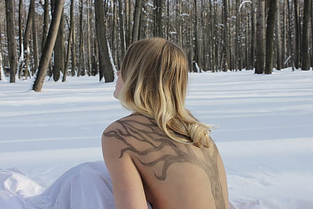 topless woman sitting on snow