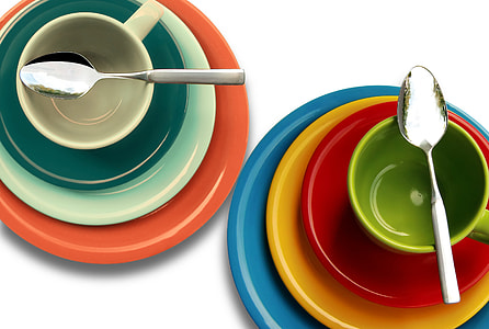 photo of assorted-color of plates, bowls, saucers, and cups with stainless steel spoons