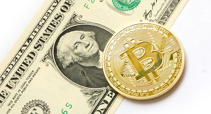 Bitcoin on top of U.S. dollar banknote