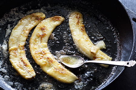 three fried bananas on frying pad with spoon