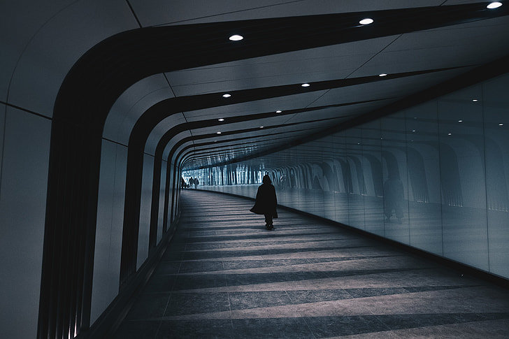 Person walking in modern city tunnel