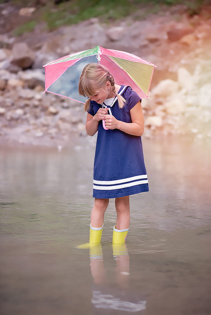 girl wearing blue dress and holding umbrella