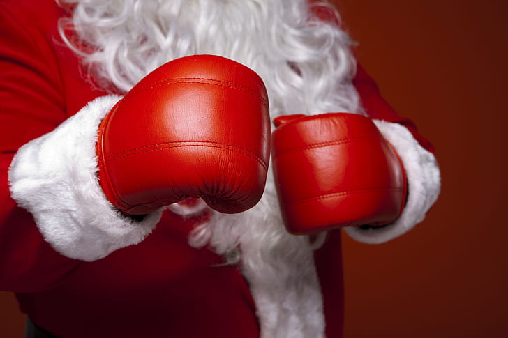 Santa Claus wearing red boxing gloves