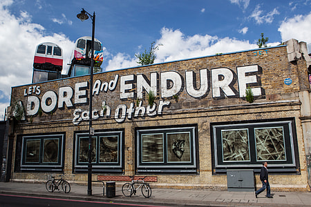‘Adore and Endure’ street art captured in Shoreditch, East London