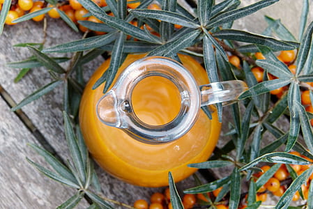clear glass pitcher near small round fruit