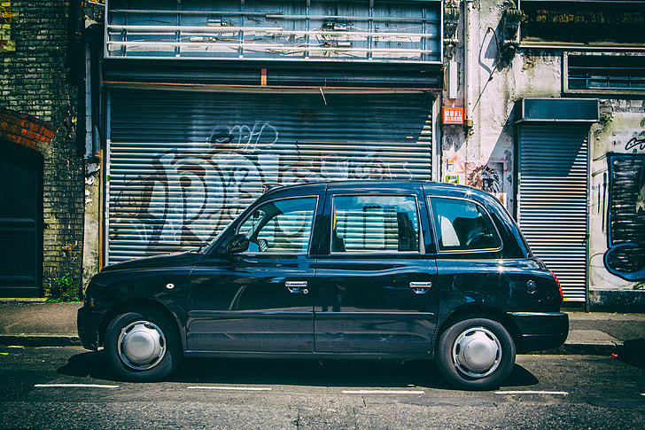 Wide-angle street shot of a black London taxi in East London, image captured with a Canon 5D DSLR