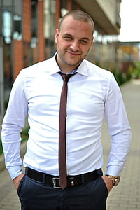 man wearing white dress shirt and brown necktie