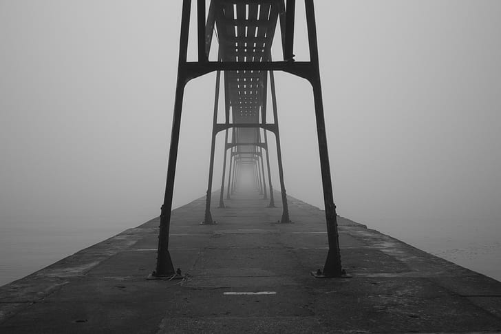 gray scale photo of road with fogs