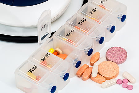 assorted medicine pills in clear medicine organizer