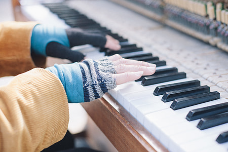 selective focus photography of person playing piano