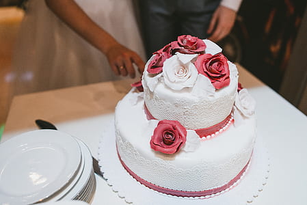 closeup photo of 2-tier cake with flower accent