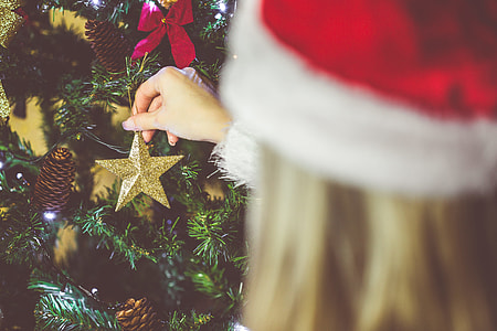 Young Woman Decorating a Christmas Tree