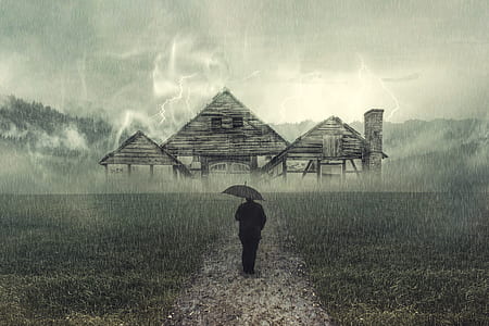 person with umbrella with house background