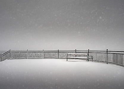 Snow Covered Bench on a Snowy Day