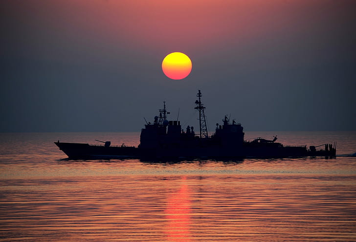 boat against sun silhouette photo