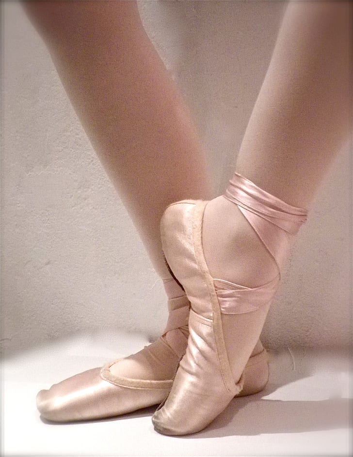 woman wearing pink ballet shoes