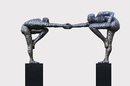 two person holding hands statue