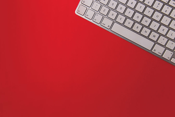 Wireless computer keyboard on a red background