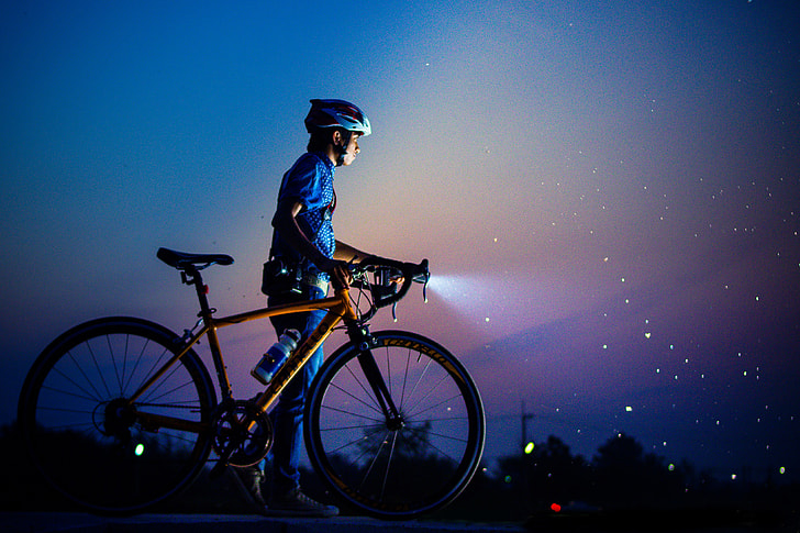 Man out with bicycle at night