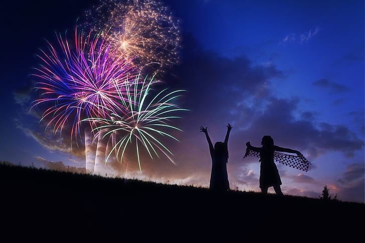 photography of silhoutte of two persons watching fireworks