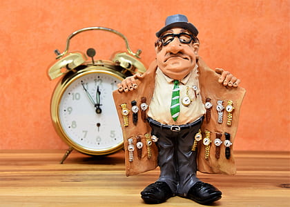 man showing watch on his coat figurine
