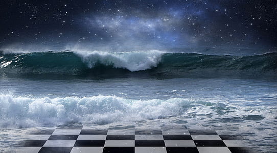 sea waves on black and white checkered floor during night time