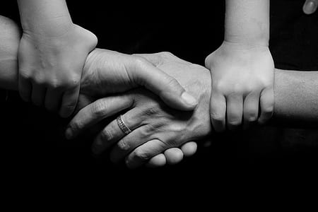 grayscale photo of person holding hands