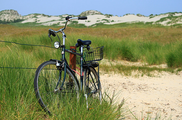black dutch bicycle surrounding by green grass field during daytime