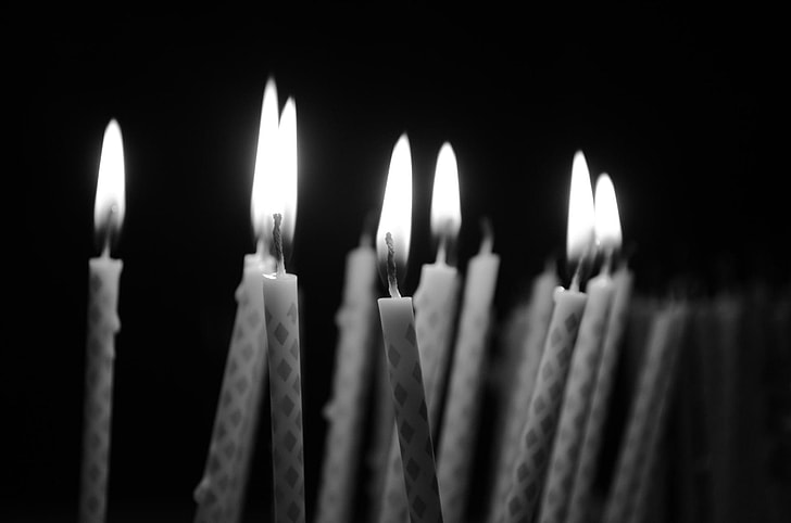 grayscale photography of lot of candle