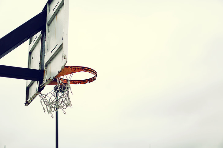 white and black basketball hoop during cloudy day