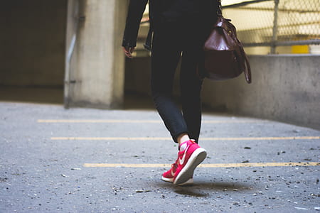 person wearing pink Nike running shoes