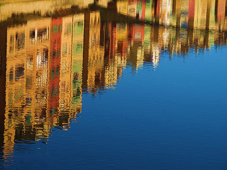Reflection of High Rise Buildings of Calm Body of Water during Daytime