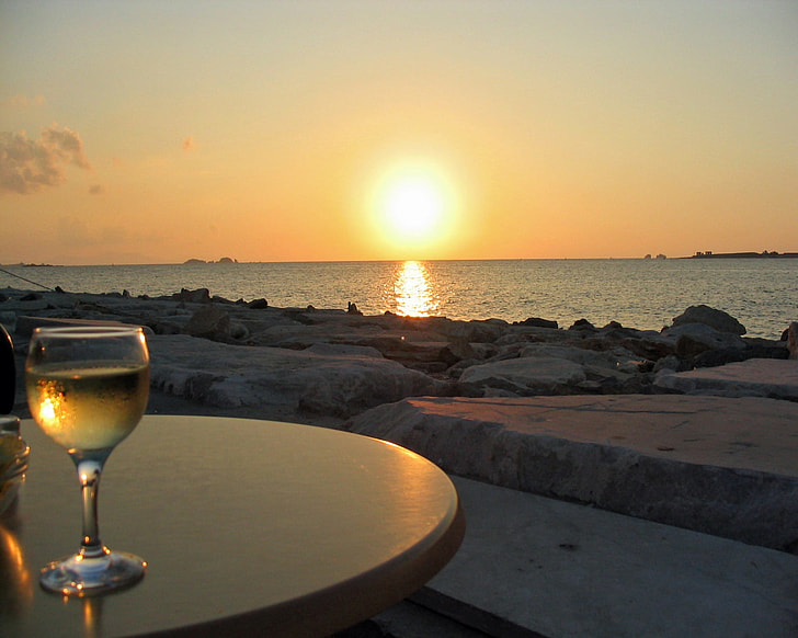 clear wine glass on table during sunset