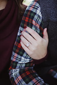 Woman Wearing Silver-colored Solitaire Ring Holding Person's Arm