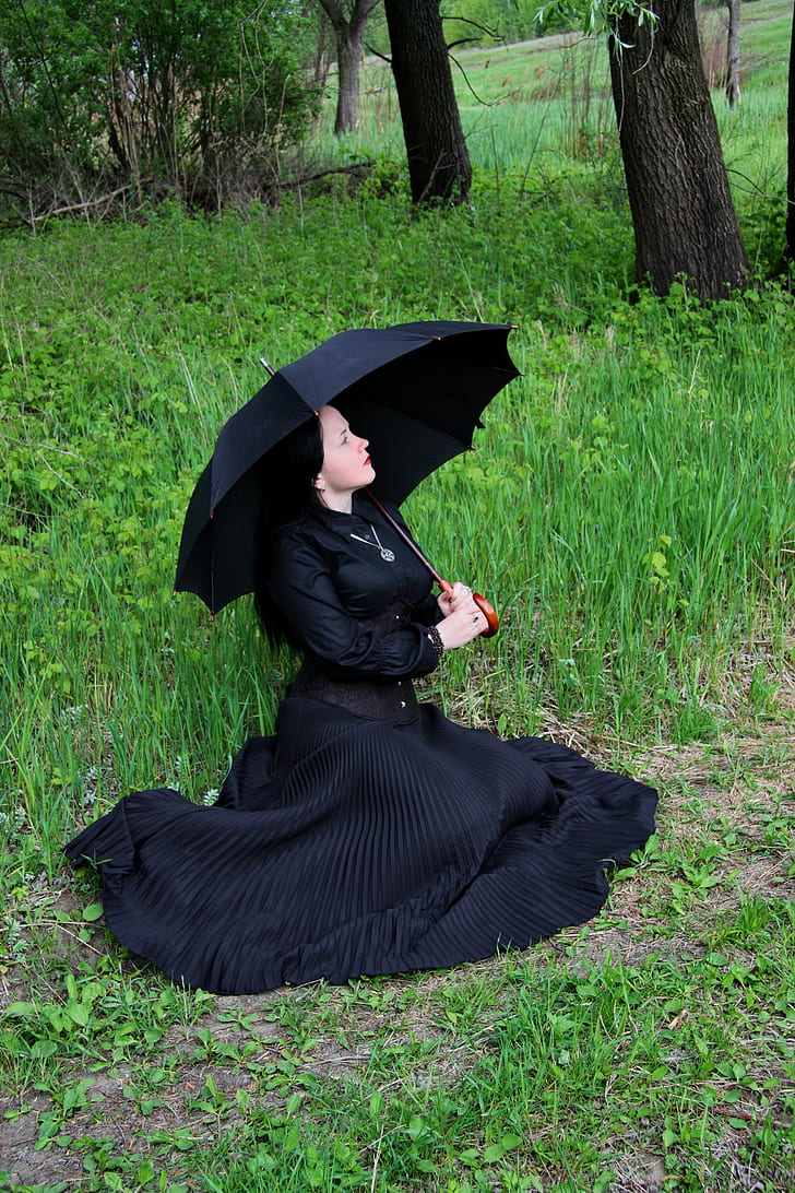 woman wearing dress holding umbrella