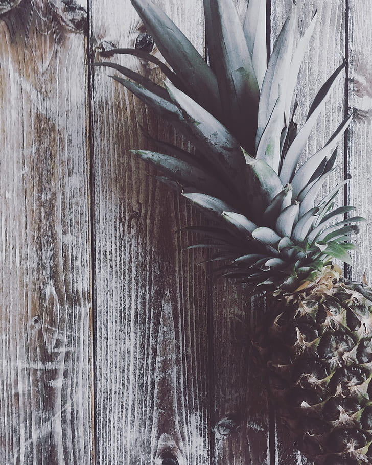 photo of pineapple on brown wooden table