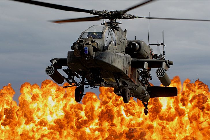 gray apache helicopter with blazing fire background