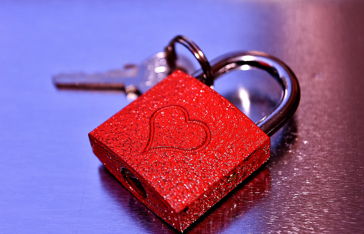 red and silver padlock with key