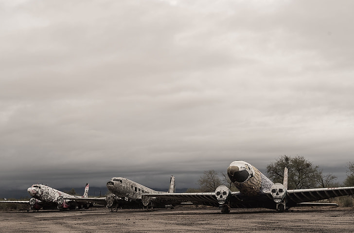 three white passenger planes under gray sky during daytime