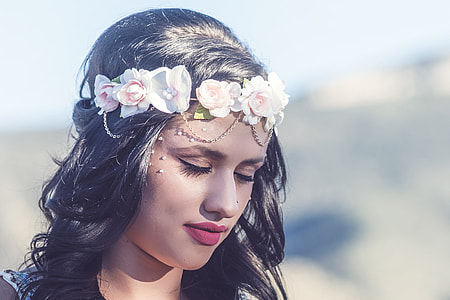 woman in red lipstick wearing pink floral crown